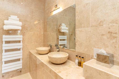 a bathroom with two sinks and a large mirror at Asquith Hall Hotel & Spa Scarborough in Scarborough