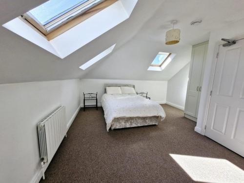 a bedroom with a bed and two skylights at Parochial View in Athboy