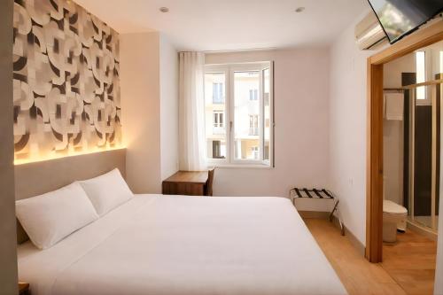 Llit o llits en una habitació de Hotel Elizalde