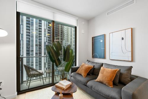 a living room with a couch and a large window at Prime Downtown Condo with City Views in Miami
