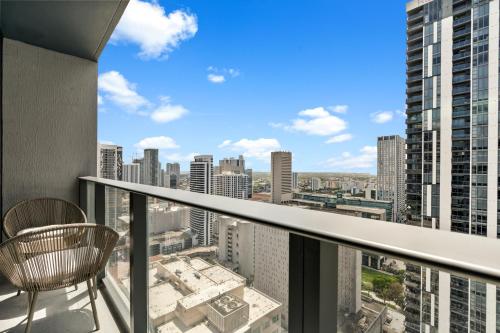 a balcony with a chair and a view of the city at Prime Downtown Condo with City Views in Miami
