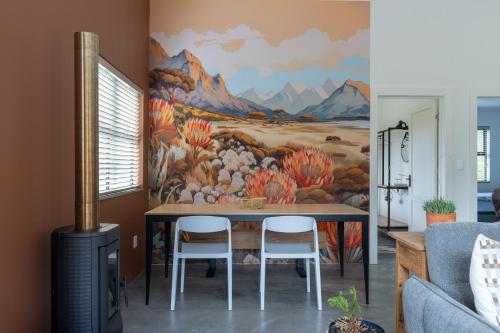 a dining room with a mural of mountains at Cape Dutch Stay, Suite A in Sedgefield