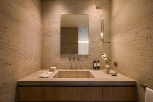 a bathroom with a large tub with a mirror at Dia Dyo Residences in Pefki