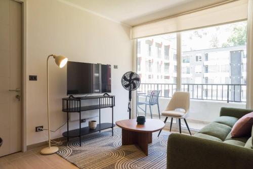 a living room with a couch and a flat screen tv at Chic Providencia Apt 2BR 2BA Sleeps 5 in Santiago