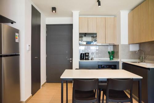 a kitchen with a table and chairs in a room at Chic Providencia Apt 2BR 2BA Sleeps 5 in Santiago