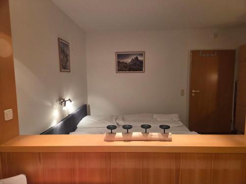 a bedroom with a bed with four controllers on it at Apartmentanlage am Kellerberg in Zandt