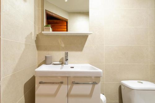 a bathroom with a sink and a toilet at Urban Nest in Sevran
