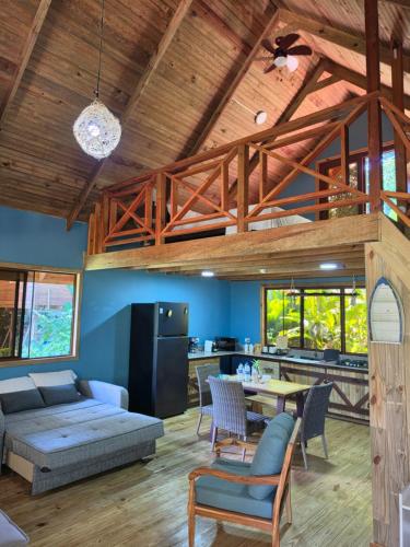 a living room with a couch and a table at The Pause EcoCabin Bocas del Toro in Bocas Town