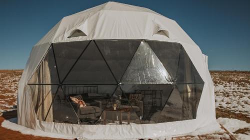 a tent with a table and chairs in it at Chief Mountain Cabins in Carway