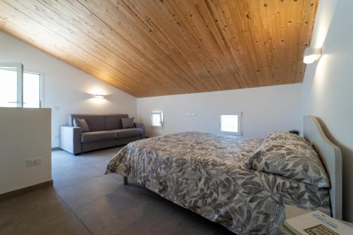 a bedroom with a bed with a wooden ceiling at GuestHost - Borgo 84 Marzamemi - Terrazza Mare in Marzamemi