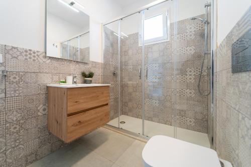 a bathroom with a shower and a sink and a toilet at GuestHost - Borgo 84 Marzamemi - Terrazza Mare in Marzamemi