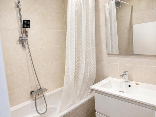 a bathroom with a shower curtain and a sink at L'échappée Méditerrannée in Vallauris