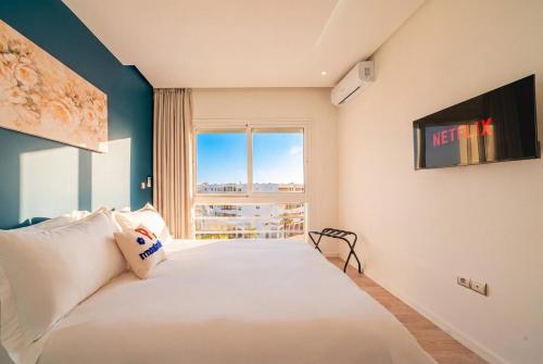 a bedroom with a large bed with a window at Ocean Breeze 2BR Ocean View Rabat Corniche in Rabat