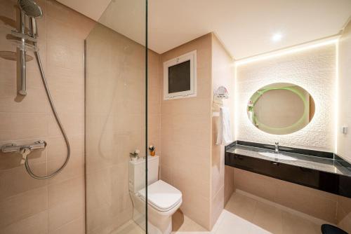 a bathroom with a shower and a toilet and a sink at Ocean Breeze 2BR Ocean View Rabat Corniche in Rabat
