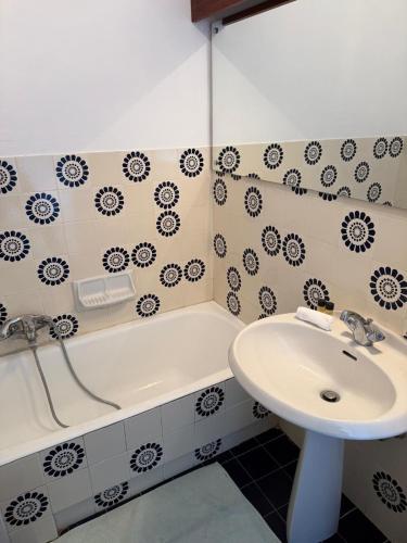 a bathroom with a sink and a bath tub at Azur Couple Studio in Mandelieu-La Napoule