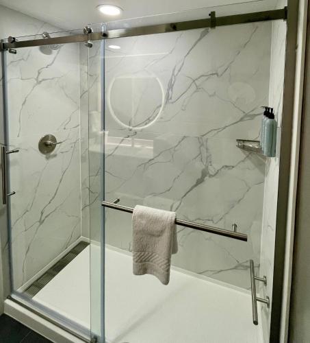 a bathroom with a shower with a glass door at Courtyard by Marriott Jacksonville I-295/East Beltway in Jacksonville