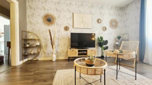 a living room with a flat screen tv on a wall at Refuge des Rêves in Amnéville