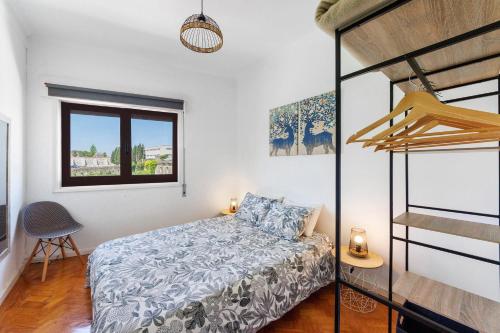 a bedroom with a bed and a bunk bed at Azuaga House Sunny Charming Apt in Vila Nova de Gaia