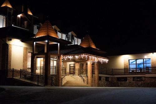 a building with christmas lights on it at night at Zolota Gora Hotel-Rancho in Uzhhorod