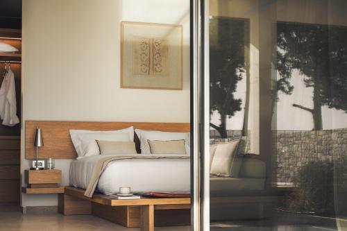 a bedroom with a bed with white sheets and pillows at Dia Dyo Residences in Pefki