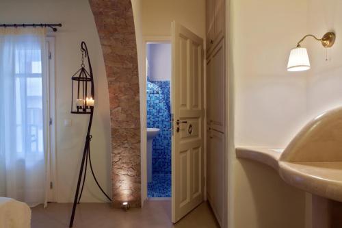 a bathroom with a sink and a mirror in a room at Tinos Aqua Palazzo in Tinos