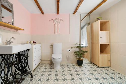 a bathroom with a toilet and a sink at Les Orchidées - Chambre in Savignac-de-Miremont