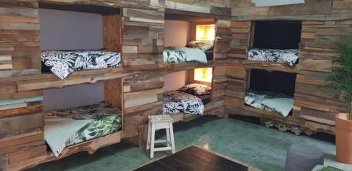 a room with a bunch of bunk beds at Santa Cruz Surf House by Stoke Travel in A dos Cunhados