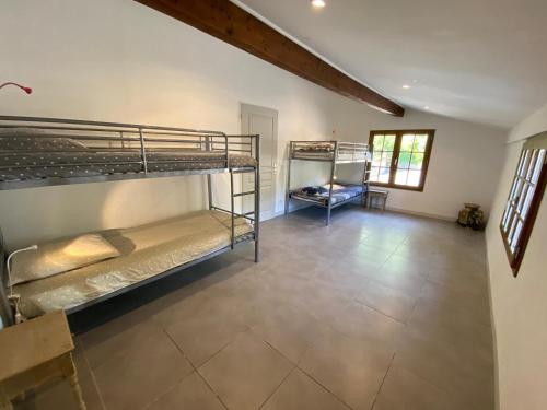 two bunk beds in a room with a tile floor at Villa les Jules in Thoard