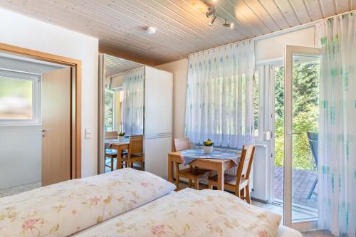 a bedroom with a bed and a dining room with a table at Spinnertonihof in Bad Peterstal