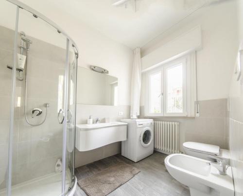 a bathroom with a sink and a washing machine at Appartamenti Federica 12T in Milano Marittima