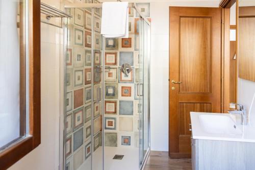a bathroom with a shower with a glass door at Residence Primera Rompala, GTSGroup in Tignale
