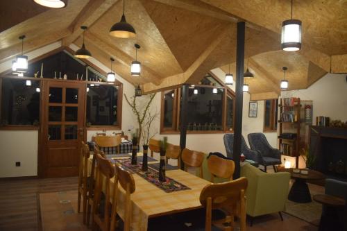 a dining room with a wooden table and chairs at Roots & Rustle homestay in Kūfrī