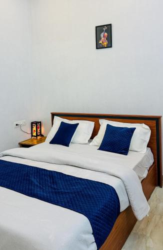 two beds sitting next to each other in a bedroom at CloudNine Stay in Sultan Bathery