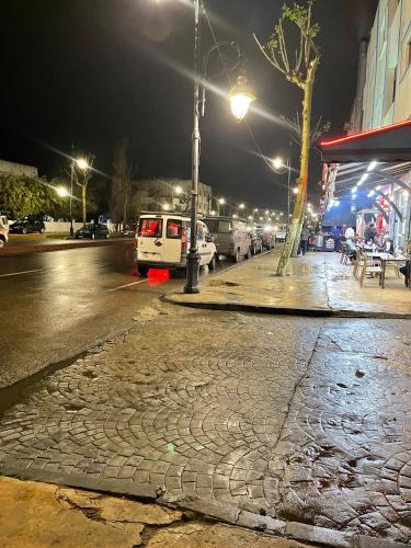 a cobblestone street at night with a street light at Central Private Haven in Martil
