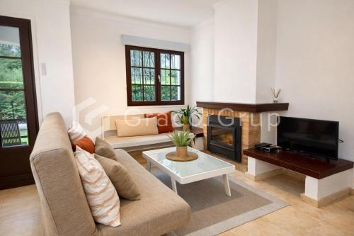 a living room with a couch and a fireplace at Casa El Trebol in L'Escala