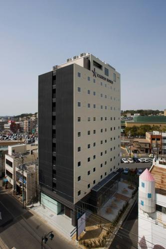 a tall black building with a sign on it at Candeo Hotels Handa in Handa