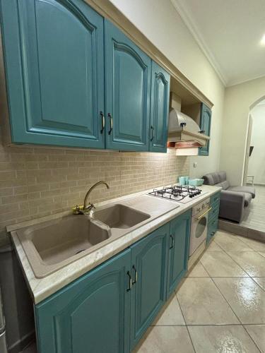 a kitchen with blue cabinets and a sink at MareLuna in Torre del Greco