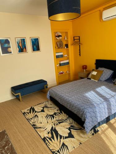 a bedroom with a bed and a rug at Le Petit Jard'Inn in Chalons en Champagne