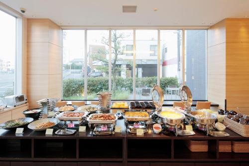 a buffet with many different types of food on a table at Candeo Hotels Handa in Handa