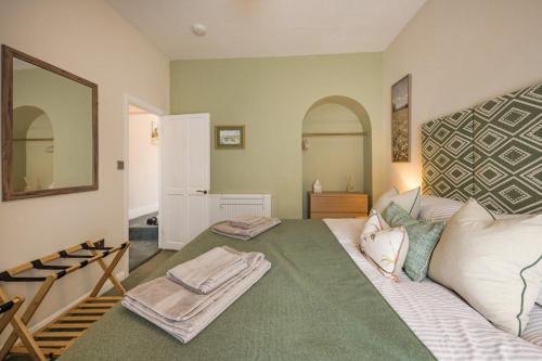 a living room with a white couch and a mirror at 2 Bed in Kingsteignton oc-w34194 in Kingsteignton