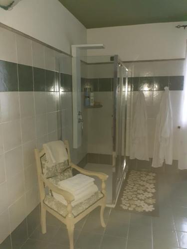 a bathroom with a shower with a chair in it at Bellavista Coghinas in Oschiri
