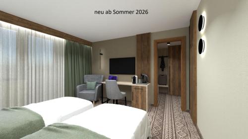 a hotel room with a bed and a desk at Hotel Post Fusch in Fusch an der Glocknerstraße