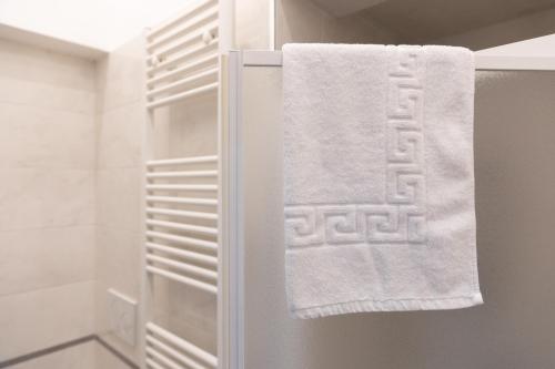 a towel hanging on the door of a refrigerator at A Casa di Paola B&B Lecce in Lecce