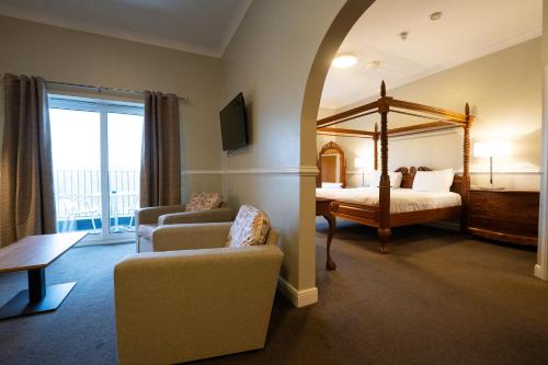 a room with a bedroom with a canopy bed at Southview Park Hotel in Skegness