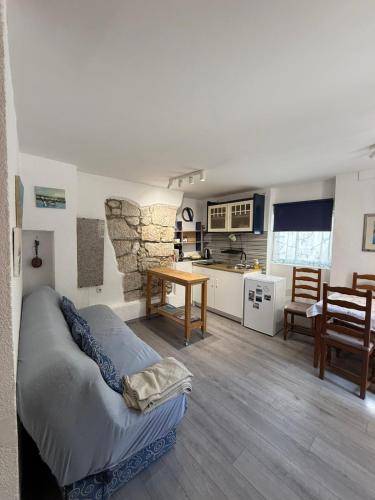 a living room with a bed and a kitchen at Apartments Rome in Baška