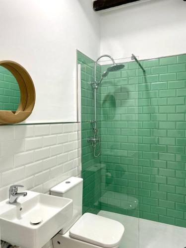 a bathroom with a toilet and a sink and a shower at Galteo Alameda in Ronda