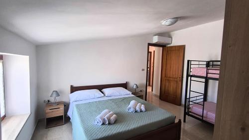 a bedroom with a bed with two towels on it at L'Imperiale Granaio Casa Vacanze in Rocca Imperiale