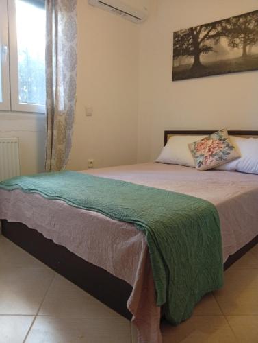 a bedroom with two beds and a window at Penelope apartment in Neoi Epivates