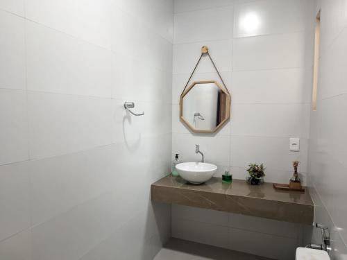 a bathroom with a sink and a mirror at yes banana in Bananeiras