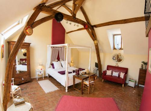 a bedroom with a bed and a table with a mirror at La Closeraie in Noyers-sur-Cher